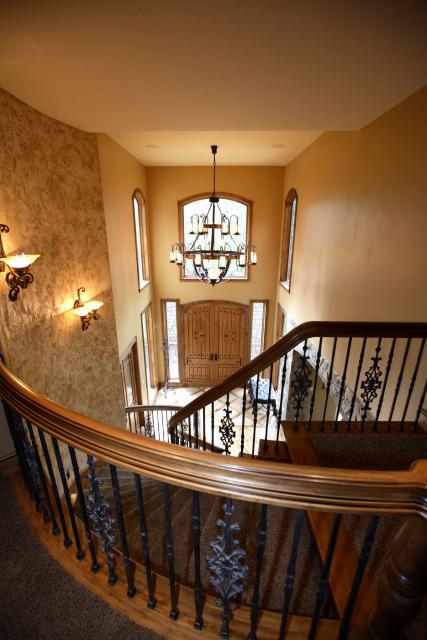 Entryway of a new home with a custom rail and staircase